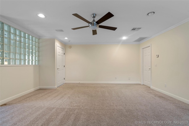 carpeted empty room with ceiling fan and crown molding