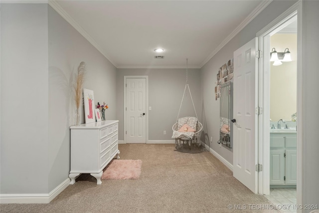 sitting room with sink, ornamental molding, and light colored carpet