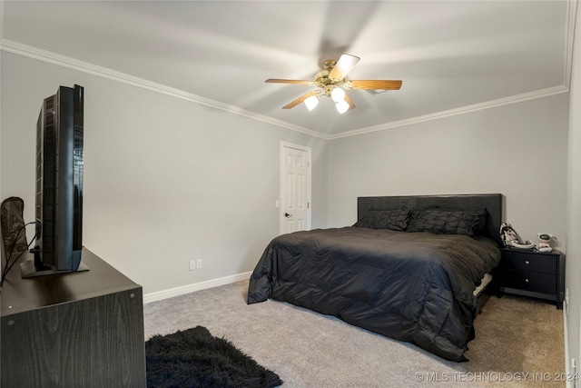 carpeted bedroom featuring ceiling fan and crown molding