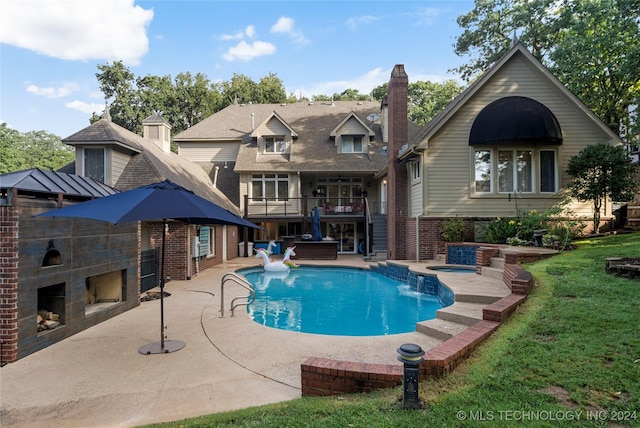 view of pool featuring a fireplace, a patio area, a water slide, and an in ground hot tub