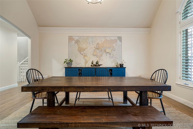 dining room with lofted ceiling and hardwood / wood-style flooring