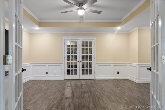 spare room featuring ornamental molding, dark wood-type flooring, french doors, and a tray ceiling