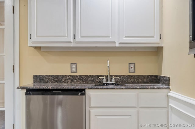 kitchen featuring sink, white cabinetry, dishwasher, and dark stone counters