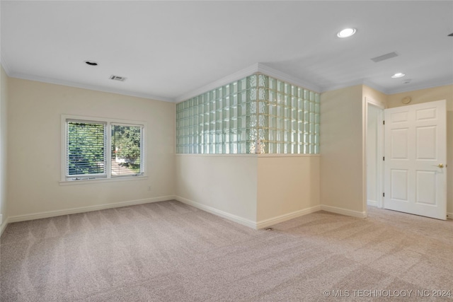 unfurnished room featuring crown molding and light colored carpet