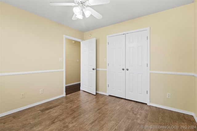 unfurnished bedroom with hardwood / wood-style floors, ceiling fan, and a closet