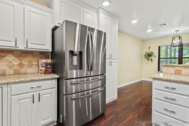 kitchen featuring decorative backsplash, white cabinetry, light stone counters, stainless steel refrigerator with ice dispenser, and dark hardwood / wood-style floors