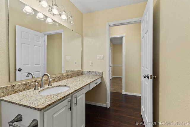 bathroom featuring hardwood / wood-style flooring and vanity