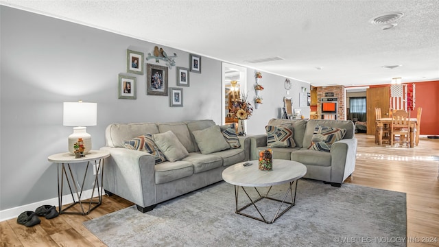 living room with hardwood / wood-style flooring and a textured ceiling