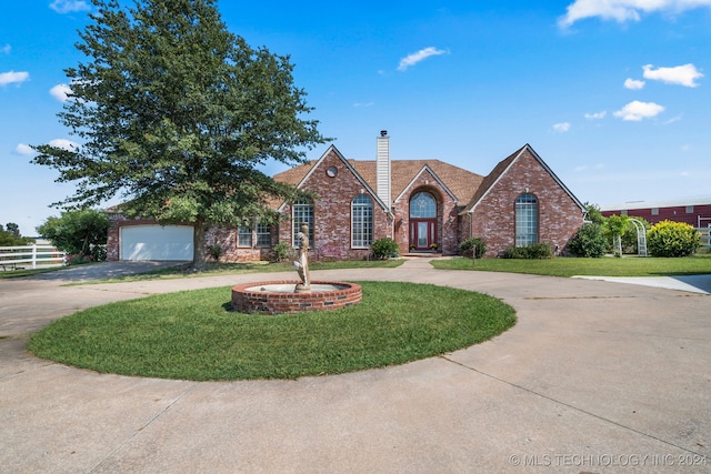 view of front of property with a garage and a front yard