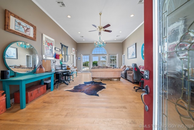 home office featuring ornamental molding, ceiling fan with notable chandelier, and light hardwood / wood-style flooring