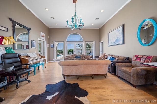 living room with ornamental molding, light hardwood / wood-style flooring, and a notable chandelier