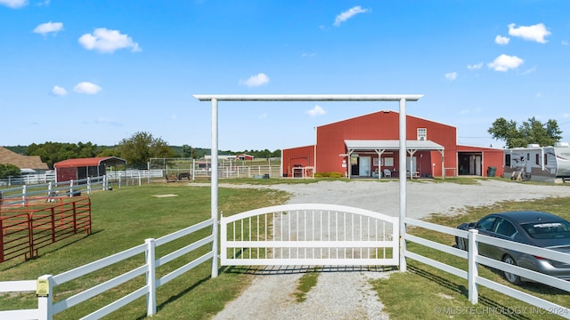 view of gate featuring an outbuilding