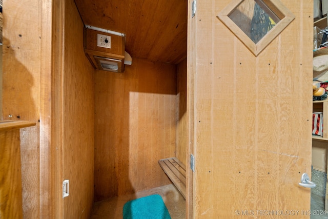 interior space with wooden ceiling and wood walls