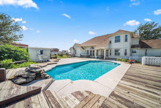 view of swimming pool featuring a deck