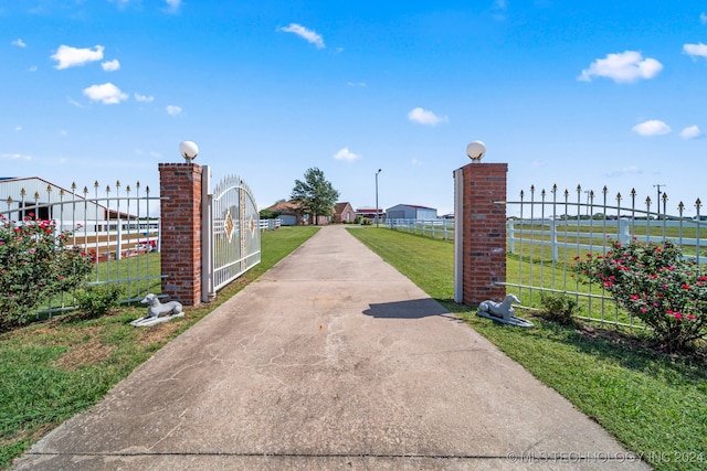 view of gate featuring a yard