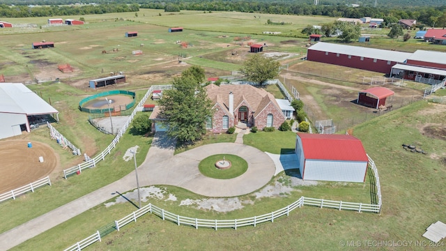 birds eye view of property with a rural view