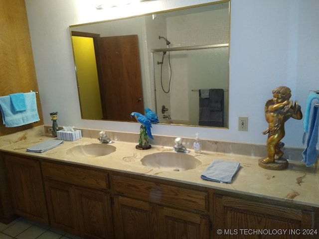 bathroom featuring walk in shower, vanity, and tile patterned floors