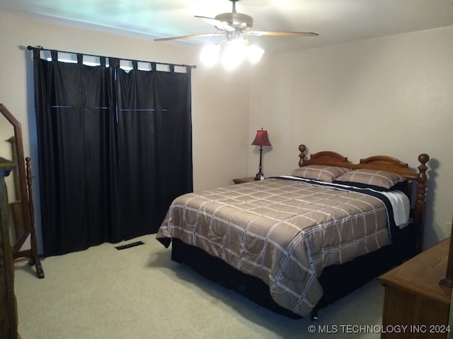 carpeted bedroom with ceiling fan