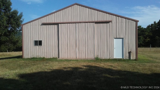 view of outbuilding featuring a lawn