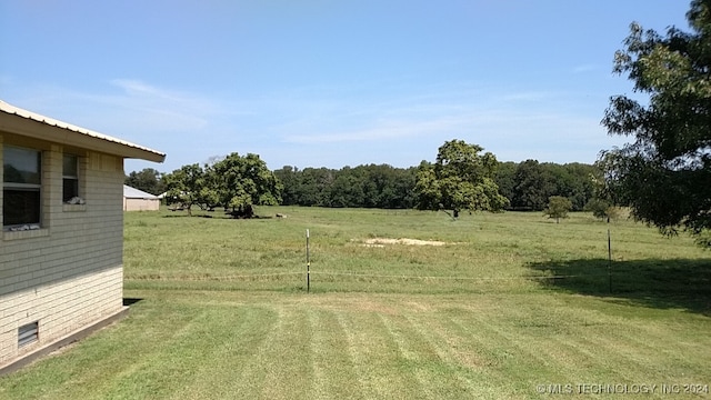 view of yard with a rural view