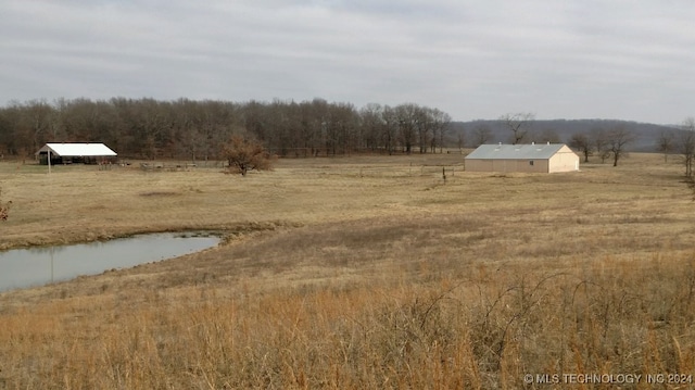 view of yard featuring a water view and a rural view