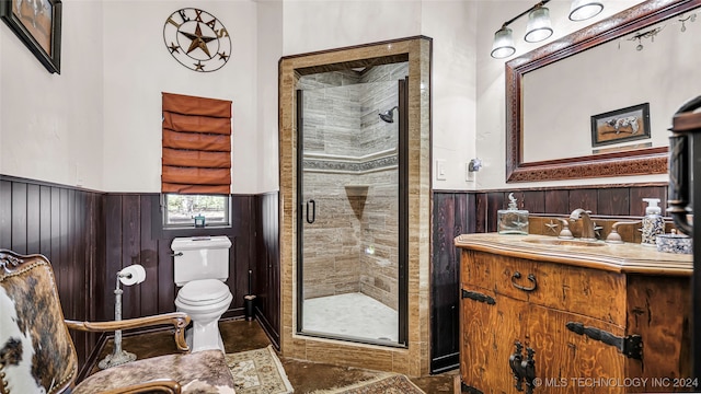 bathroom featuring walk in shower, wood walls, vanity, and toilet