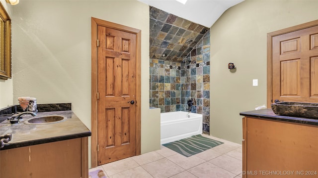 bathroom featuring tile walls, vanity, tile patterned flooring, lofted ceiling, and tiled shower / bath