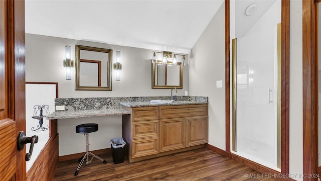 bathroom with vanity, hardwood / wood-style flooring, and a shower with door