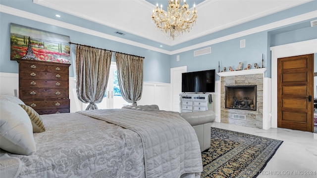 bedroom with ornamental molding, a chandelier, and a tray ceiling