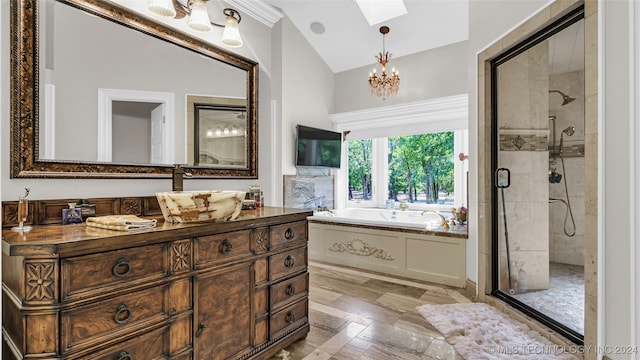 bathroom featuring plus walk in shower, vaulted ceiling with skylight, a chandelier, and vanity