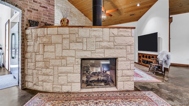 room details featuring wood ceiling, concrete floors, ceiling fan, and a fireplace