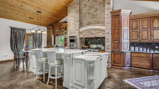 kitchen featuring an island with sink, light stone countertops, high vaulted ceiling, and decorative backsplash