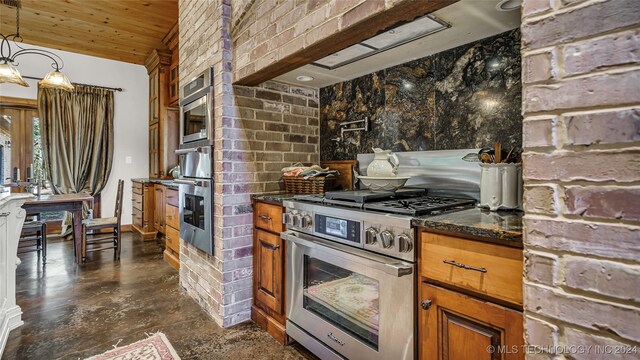 kitchen with appliances with stainless steel finishes, hanging light fixtures, dark stone countertops, and wooden ceiling