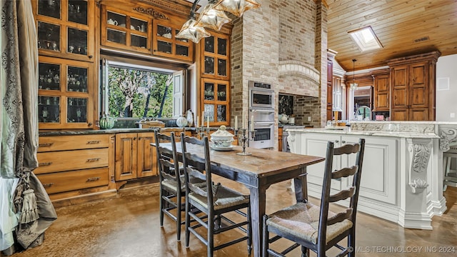 dining space featuring sink, a skylight, a high ceiling, brick wall, and wooden ceiling