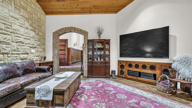 living room with wood ceiling and high vaulted ceiling