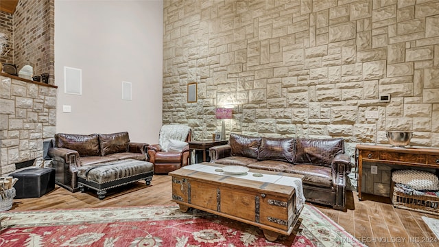 living room featuring wood-type flooring and a towering ceiling