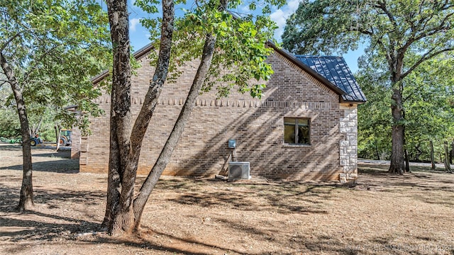 view of side of home featuring central AC