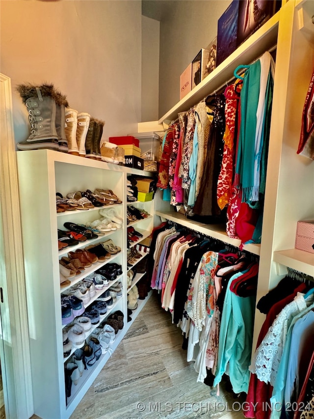 spacious closet featuring hardwood / wood-style floors