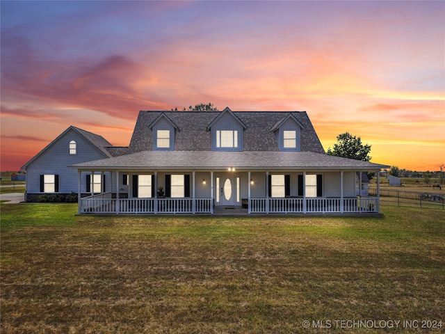 view of front of property featuring a yard and covered porch