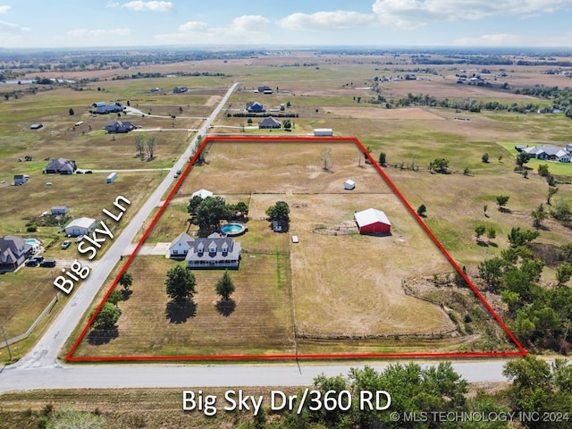 birds eye view of property with a rural view