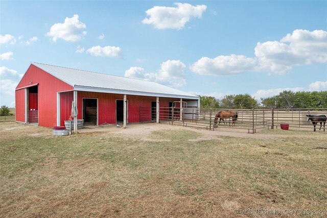 view of horse barn featuring a rural view