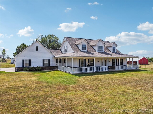 farmhouse with a front yard and covered porch