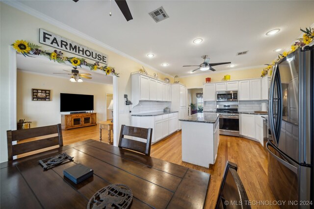 dining area featuring crown molding and light hardwood / wood-style floors