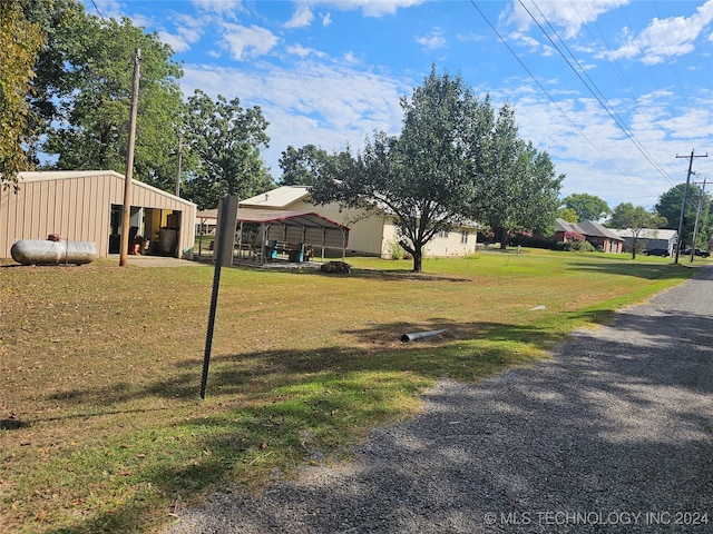 view of yard with an outbuilding and a carport