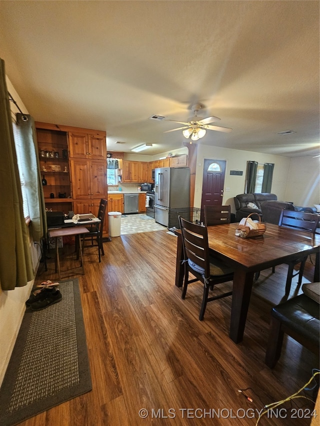 dining area featuring wood-type flooring and ceiling fan