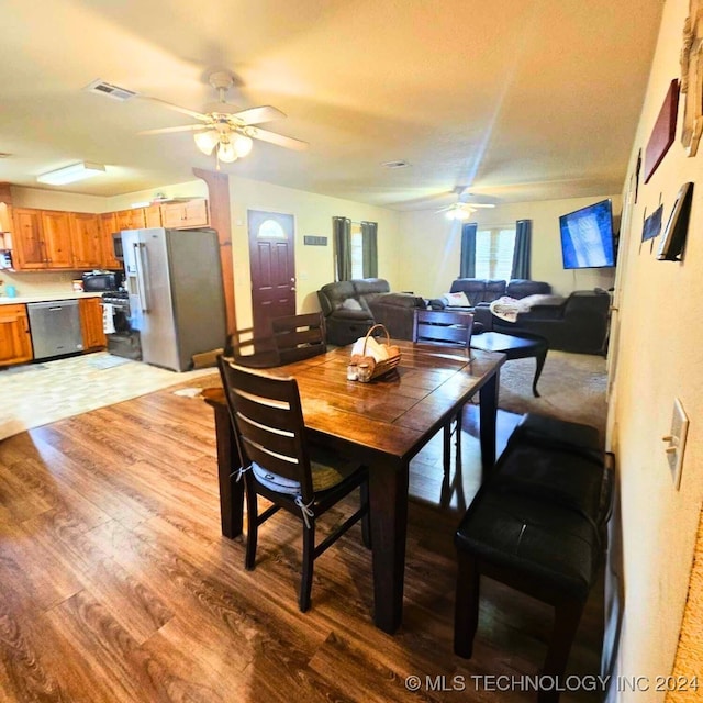 dining space with light hardwood / wood-style floors and ceiling fan