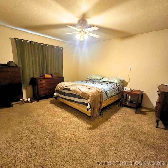 bedroom featuring ceiling fan, a textured ceiling, and carpet