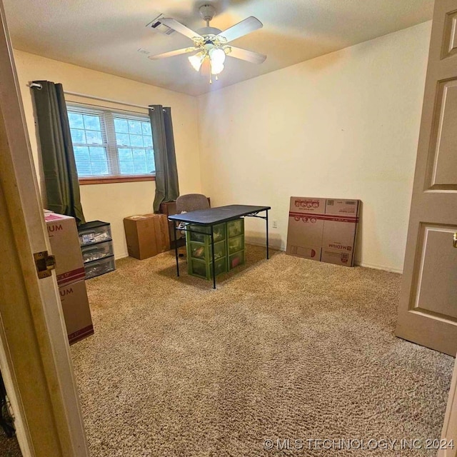 carpeted home office with ceiling fan