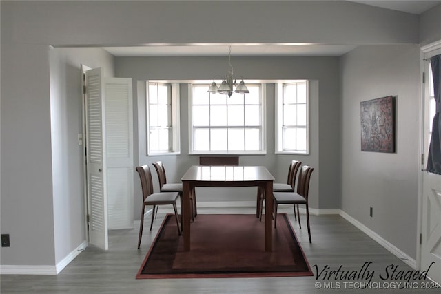 dining room featuring hardwood / wood-style floors and a chandelier