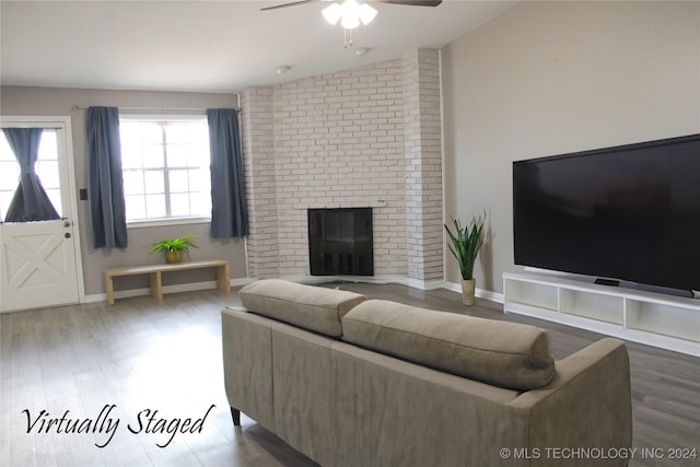 living room featuring hardwood / wood-style flooring, ceiling fan, lofted ceiling, and a fireplace